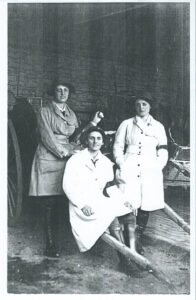 Three land girls in uniform at The Grange, Gunthorpe, Peterborough c1917