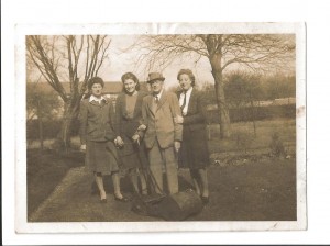 Joan and Geoff Shutte Archive Photo 8 Text on back of photo 'Theo, her Pap, Cousin Jane and myself. Taken while spending a lovely time at Keynsham. March '44'