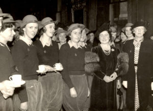 Land Girls standing next to Queen Elizabeth (later Queenmother) and Lady Gertrude Denman