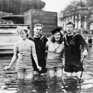 VE DAY CELEBRATIONS IN LONDON, ENGLAND, 8 MAY 1945 (EA 65799) Two British sailors and their girlfriends wading in the fountains in Trafalgar Square on VE Day. Copyright: © IWM. Original Source: http://www.iwm.org.uk/collections/item/object/205125103